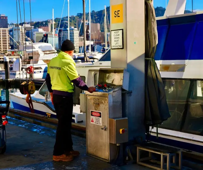 Marina staff operating the boat lift controls