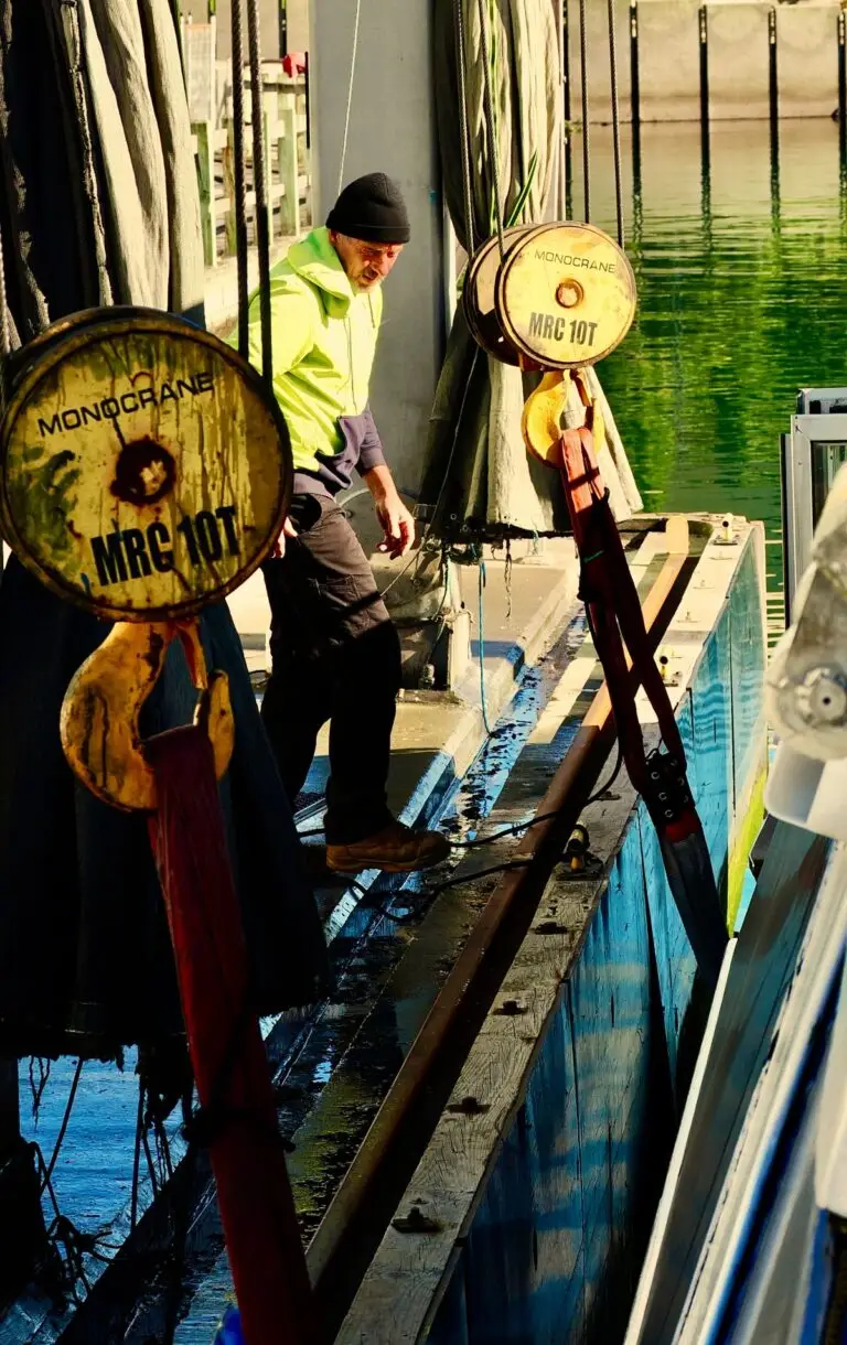 Marina crew rigging the lift slings and hook block