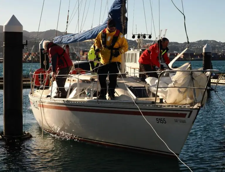 Crew aboard a yacht motoring out on a race morning