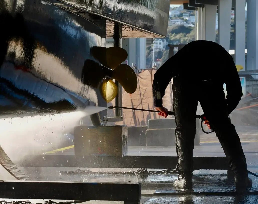 Water blasting a hull and propeller after a haul-out at Chaffers Marina