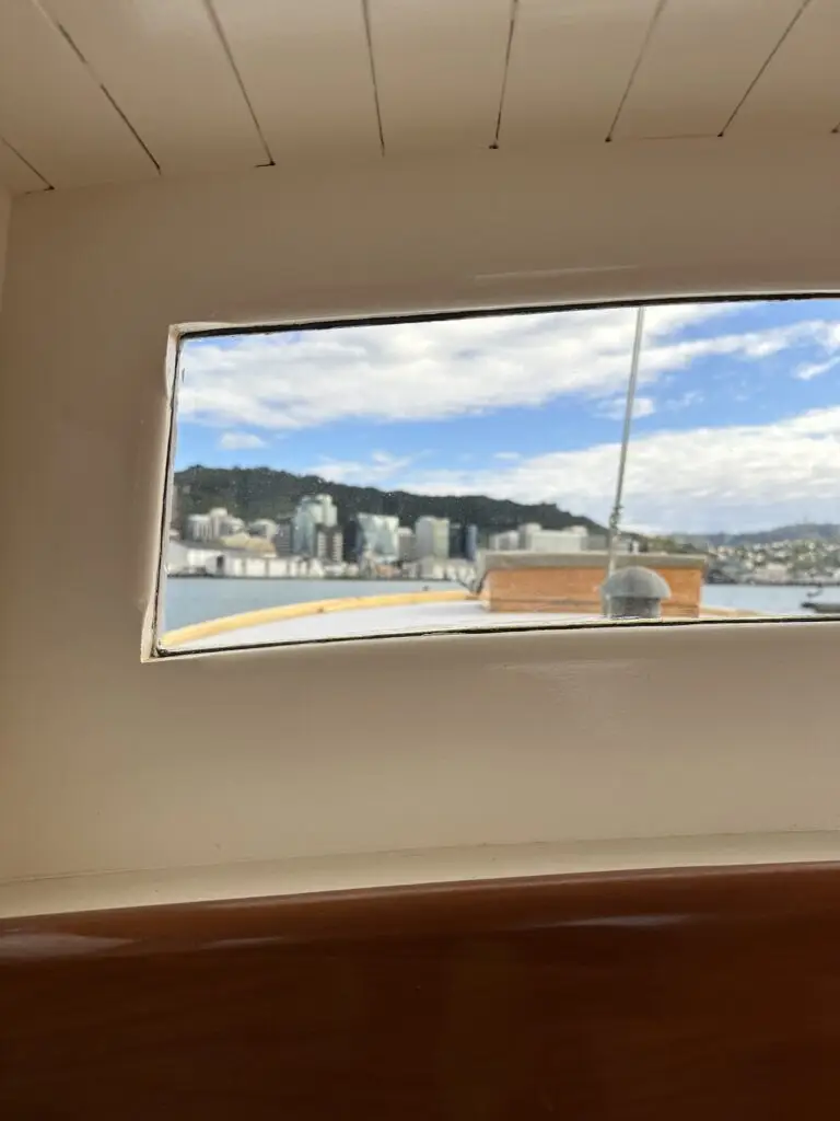 Wellington city seen through the cabin window of a boat at Chaffers Marina