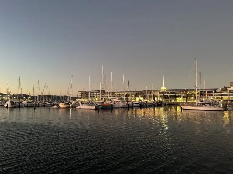 Chaffers Marina and Clyde Quay Wharf at dusk, with lights reflected in the water